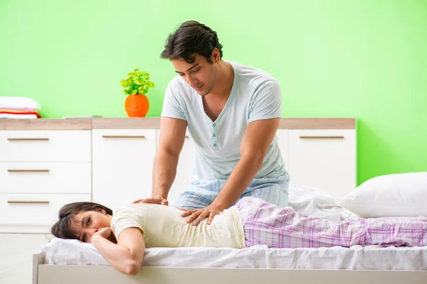 Man doet massage naar zijn vrouw in slaapkamer — Stockfoto