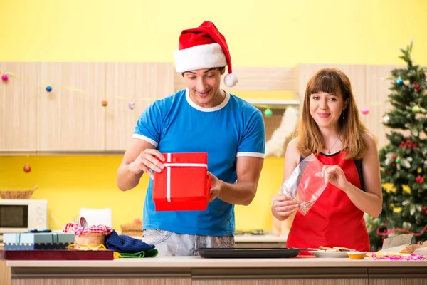 Young couple celebrating Christmas in kitchen — Stock Photo, Image