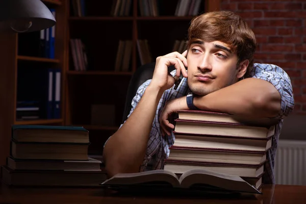 Joven estudiante guapo preparándose para los exámenes por la noche — Foto de Stock