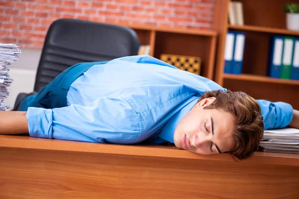 Junge Angestellte mit exzessiver Arbeit im Büro — Stockfoto