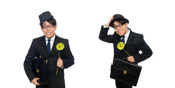 Mladý muž v černém kostýmu s květem izolovaných na bílém — Stock fotografie
