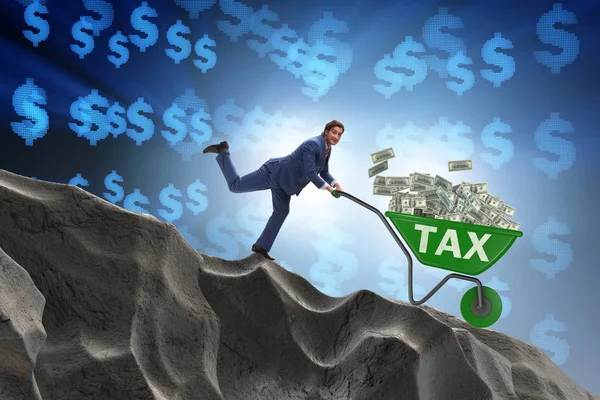 Businessman pushing wheelbarrow with tax money — Stock Photo, Image