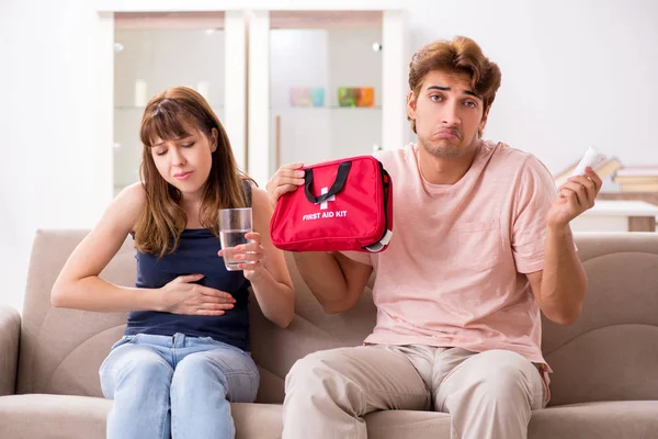 Young family getting treatment with first aid kit — Stock Photo, Image