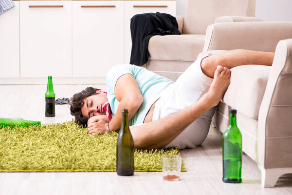 Young drunk handsome man after party at home 