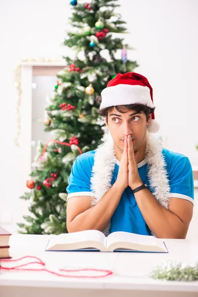 Young student with book at Christmas eve — Stock Photo, Image