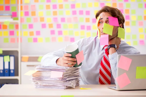 Young handsome man in conflicting priorities concept — Stock Photo, Image