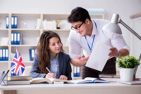 Teacher explaining to student at language training