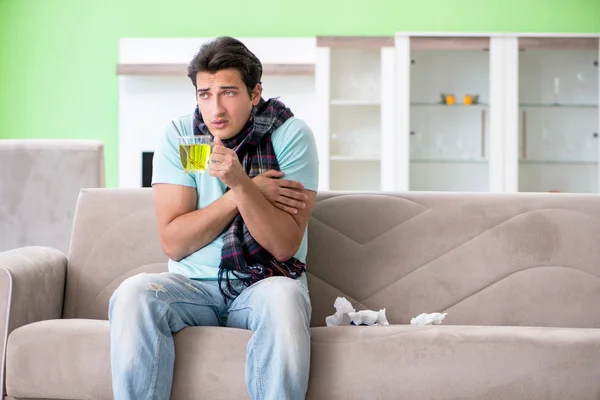 Young handsome man suffering from illness at home — Stock Photo, Image