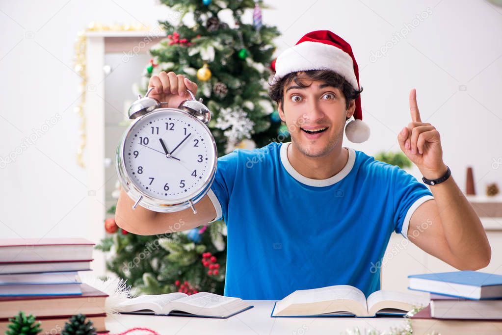 Young student with book at Christmas eve 