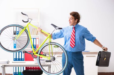 Genç işadamı işe gitmek için bisiklet kullanıyor.