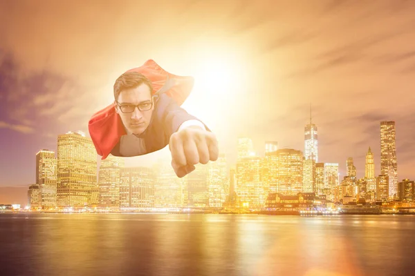 Superhero businessman flying over the city