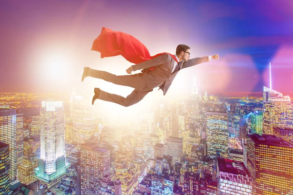 Superhero businessman flying over the city