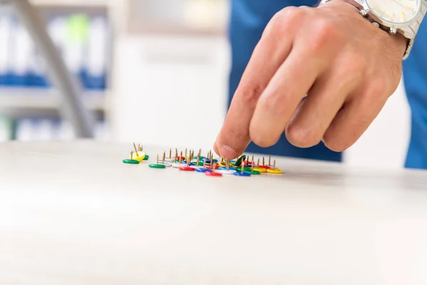 Office prank with sharp thumbtacks on chair