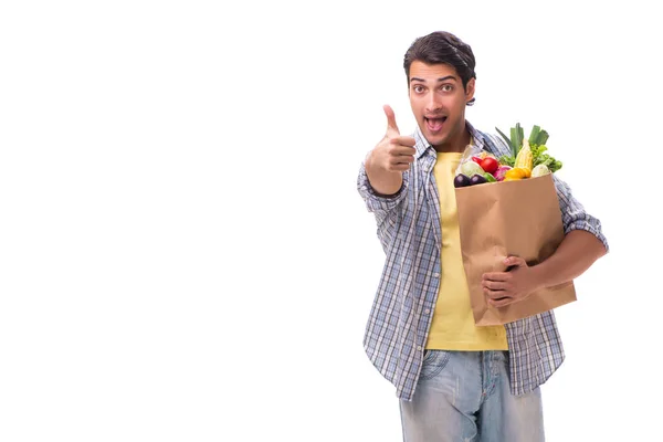 Giovane uomo con la sua spesa su bianco — Foto Stock