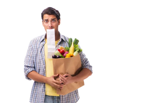 Jongeman met zijn kruidenierswinkel op wit — Stockfoto