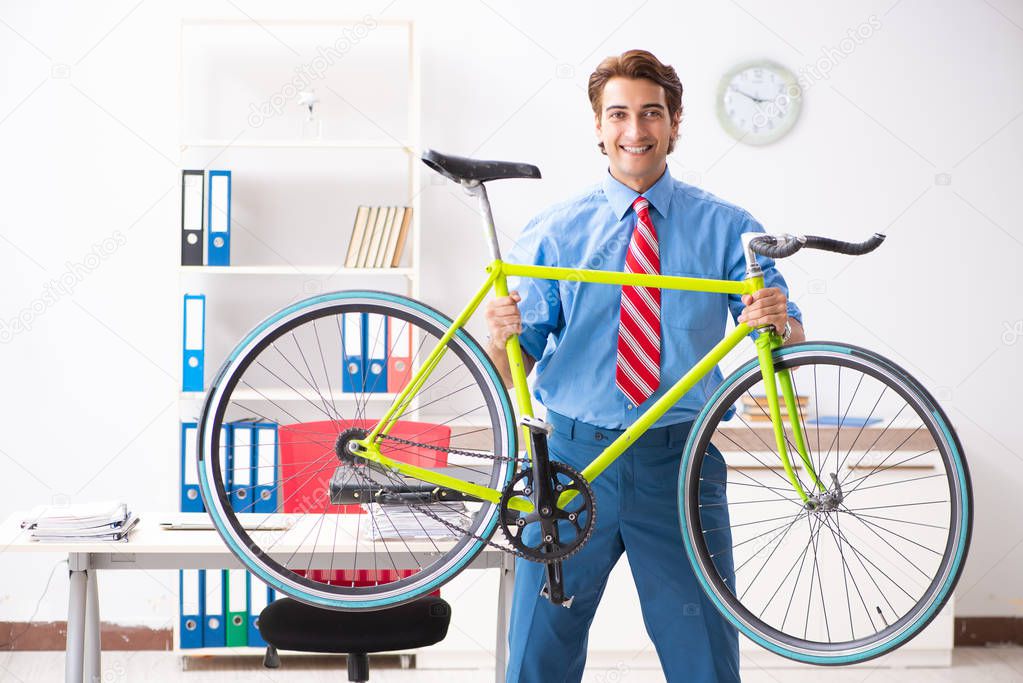 Young businessman using bike to commute to the office