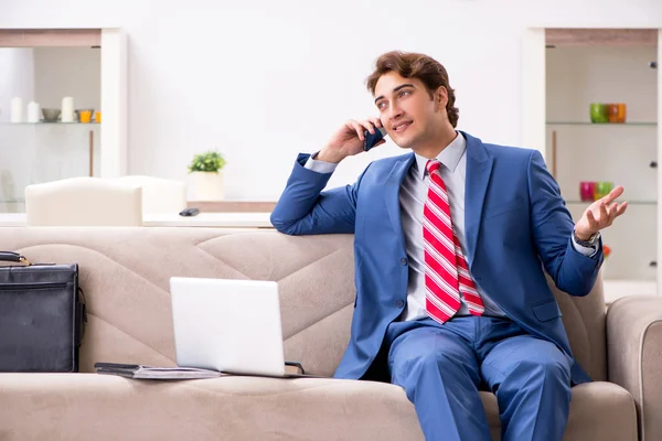 Young businessman working at home sitting on the sofa — Stock Photo, Image