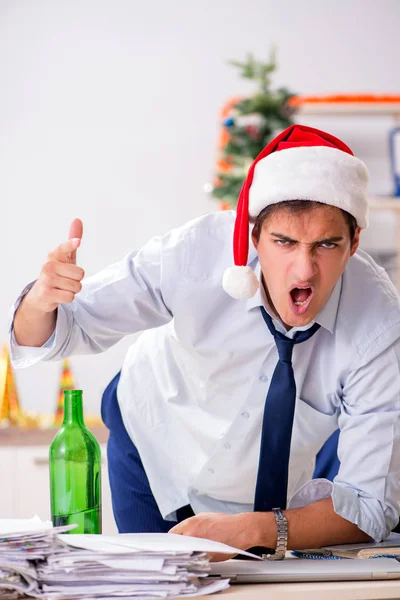 Jovem e bonito funcionário celebrando o Natal no local de trabalho — Fotografia de Stock