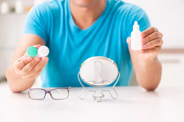 Hombre tratando de lentes de contacto en casa — Foto de Stock