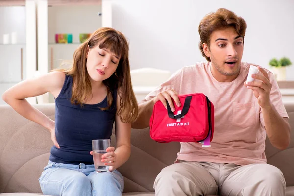 Young family getting treatment with first aid kit — Stock Photo, Image