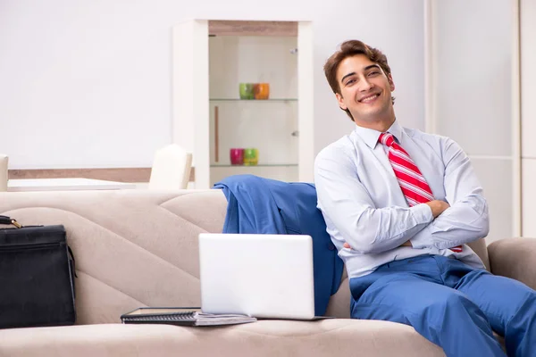 Young businessman working at home sitting on the sofa — Stock Photo, Image