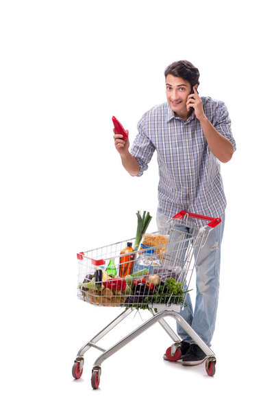 Young man with supermarket cart trolley on white