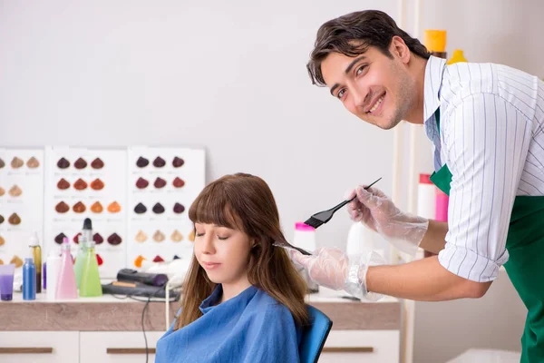 Young woman visiting young handsome barber — Stock Photo, Image