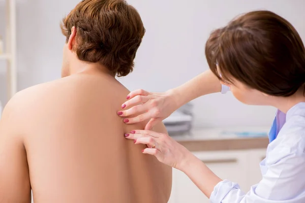 Young female doctor chiropractor massaging male patient — Stock Photo, Image