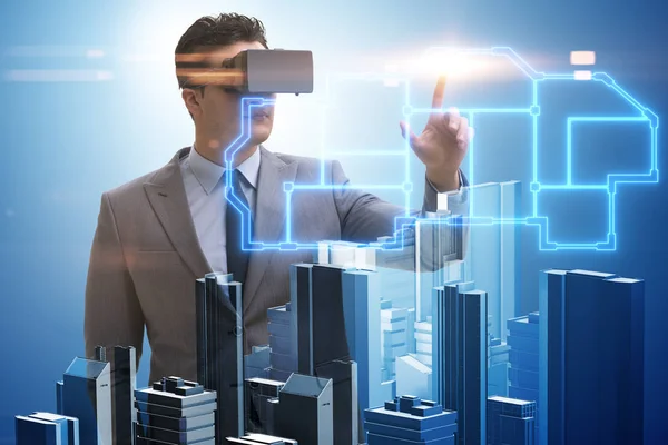 Man with virtual reality goggles doing urban planning