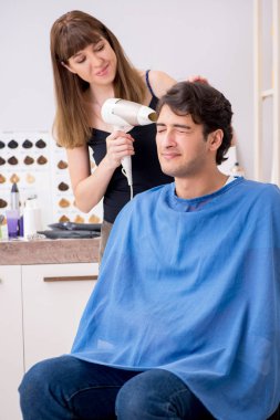 Genç çekici adam bayan berberi ziyaret ediyor. 
