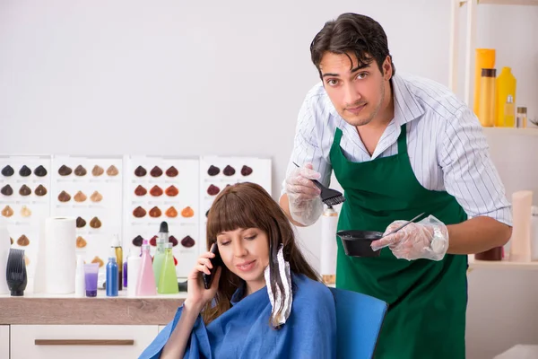 Young woman visiting young handsome barber — Stock Photo, Image