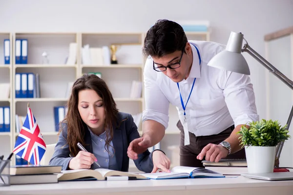 Teacher explaining to student at language training — Stock Photo, Image