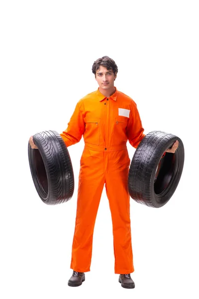 Young garage worker with tyre isolated on white — Stock Photo, Image