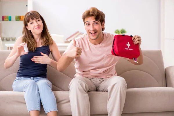 Young family getting treatment with first aid kit — Stock Photo, Image