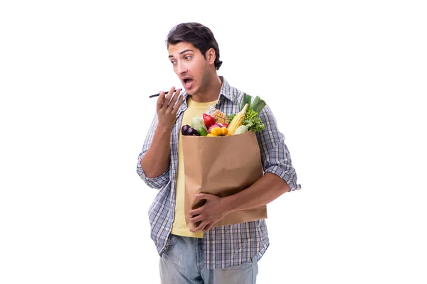 Junger Mann mit seinem Einkauf in Weiß — Stockfoto