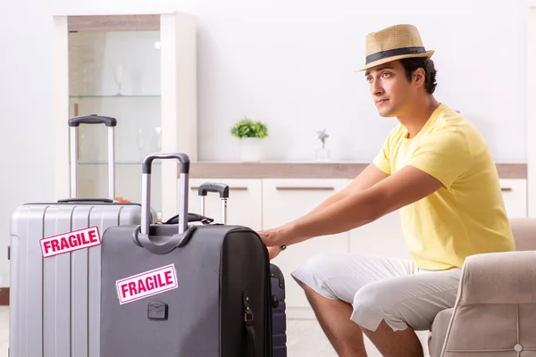 Man going on vacation with fragile suitcases