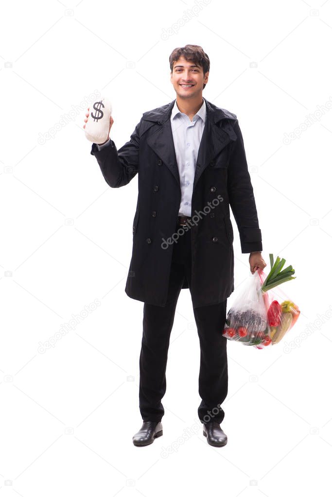 Young handsome man with vegatables in shopping concept 