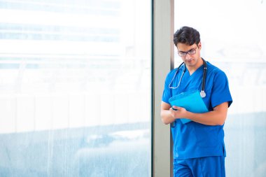 Hastanede çalışan yakışıklı genç bir doktor. 