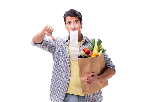 Giovane uomo con la sua spesa su bianco — Foto Stock