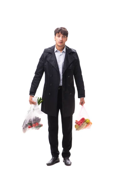 Młody przystojny mężczyzna z warzywami w koncepcji zakupów — Zdjęcie stockowe