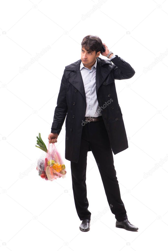 Young handsome man with vegatables in shopping concept 