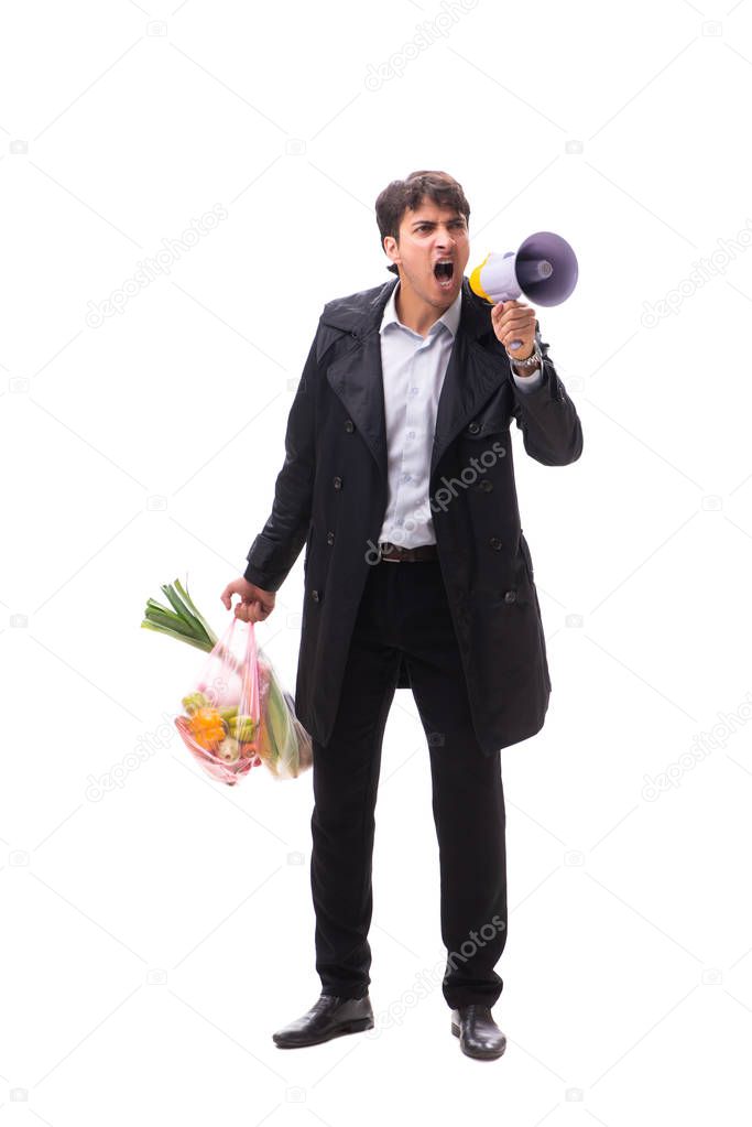 Young handsome man with vegatables in shopping concept 