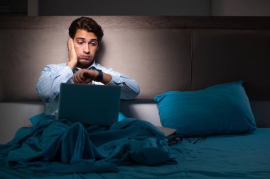 Yorgun işadamı gece fazla mesai yapıyor.