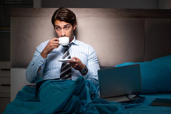 Tired businessman working overtime at home at night — Stock Photo, Image