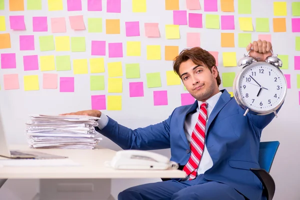 Young handsome man in conflicting priorities concept — Stock Photo, Image