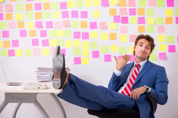 Young handsome man in conflicting priorities concept — Stock Photo, Image