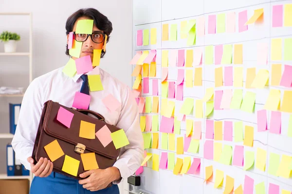 Young employee in conflicting priorities concept — Stock Photo, Image