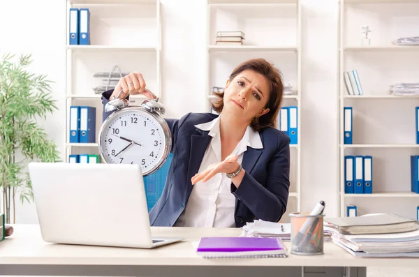 Middle-aged female employee sitting at the office — Stock Photo, Image