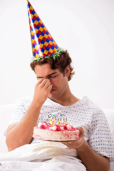 Young man celebrating his birthday in hospital