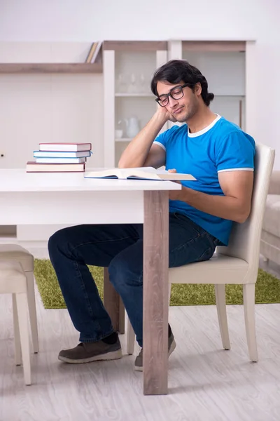 Young handsome student studying at home — Stock Photo, Image